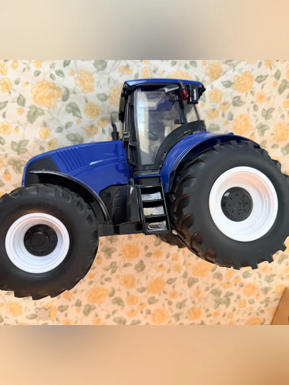 Medium plastic blue and black electronic toy tractor, lights up with sound